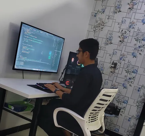 Sarim sitting on a computer table